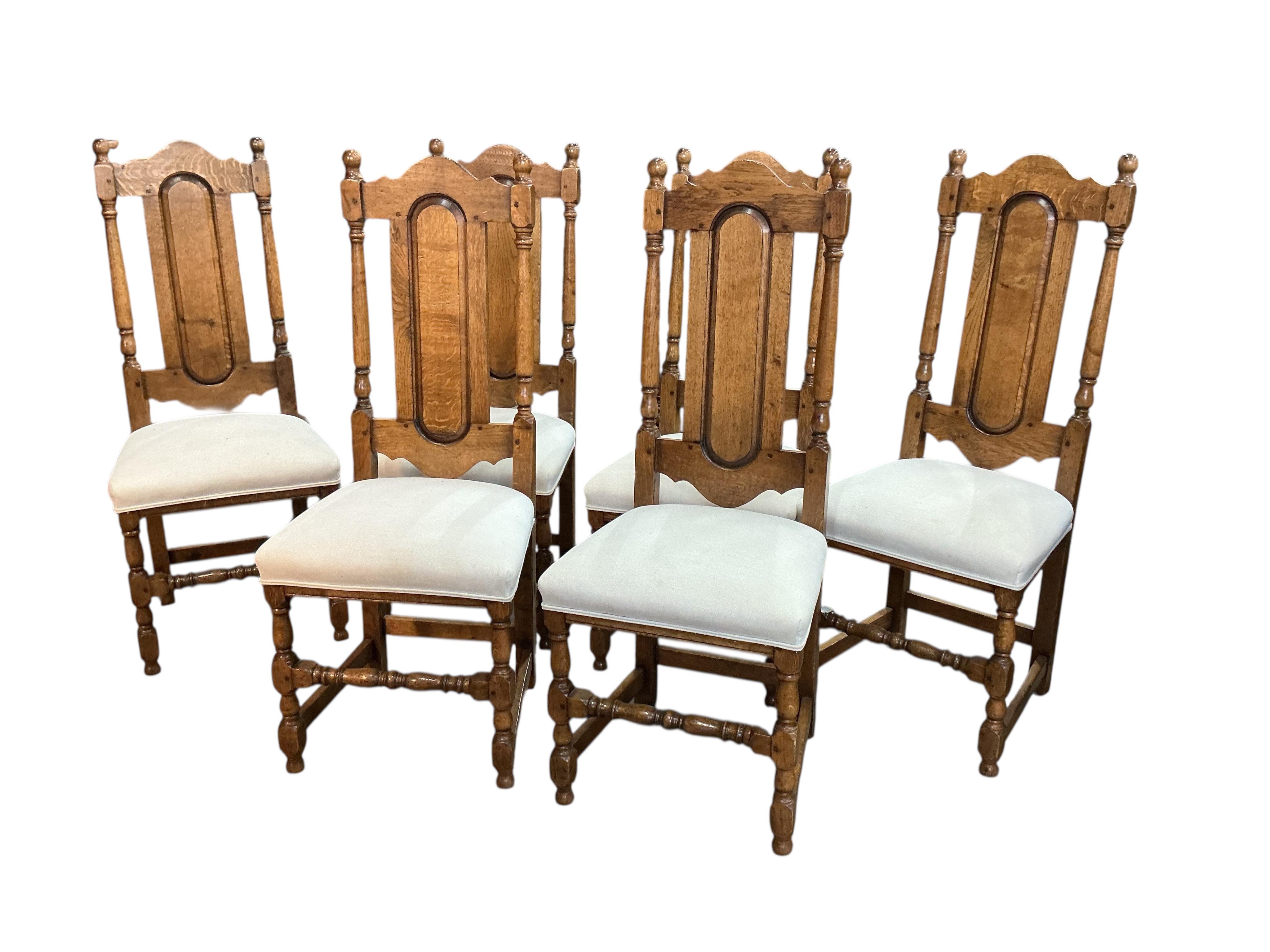 An 18th century style rectangular oak refectory dining table, width 214cm, depth 90cm, height 77cm together with six panelled oak high back dining chairs and two oak elbow chairs